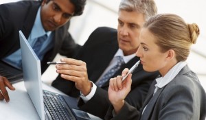 Team of business people working together on a laptop